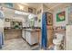 Bright bathroom featuring double sinks, decorative tile, and beach-themed décor at 3053 Conquista Ct, Las Vegas, NV 89121