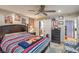 Bedroom featuring stylish decor, ceiling fan and access to the ensuite bath at 3053 Conquista Ct, Las Vegas, NV 89121