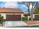 Charming single-story home featuring a brown garage door, stucco walls, and a red tile roof at 3053 Conquista Ct, Las Vegas, NV 89121