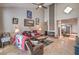 Inviting living room featuring a brick fireplace, tile floors, and plenty of natural light at 3053 Conquista Ct, Las Vegas, NV 89121