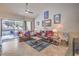 Spacious living room with tile floors, sliding glass doors to patio, and high ceilings at 3053 Conquista Ct, Las Vegas, NV 89121
