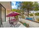 Relaxing patio swing set against a charming retaining wall decorated with colorful planters and outdoor decorations at 3053 Conquista Ct, Las Vegas, NV 89121