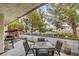 Inviting outdoor patio with a table, chairs, grill, and swing, perfect for relaxation and entertaining at 3053 Conquista Ct, Las Vegas, NV 89121