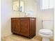 Bathroom with a vanity, mirror, and toilet, complemented by neutral walls at 3525 Hammock St, Las Vegas, NV 89147