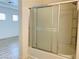 Clean bathroom featuring a shower-tub combination with sliding glass door at 3525 Hammock St, Las Vegas, NV 89147