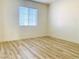 Bright bedroom featuring wood-look flooring and a window with blinds at 3525 Hammock St, Las Vegas, NV 89147