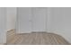 Bedroom with light wood-look flooring, white walls, and closet with bifold doors at 3525 Hammock St, Las Vegas, NV 89147