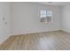 Well-lit bedroom with wood floors, a window, and neutral paint perfect for personalization at 3525 Hammock St, Las Vegas, NV 89147