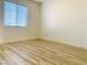 Bright bedroom featuring wood-look flooring and a window with blinds at 3525 Hammock St, Las Vegas, NV 89147