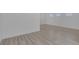 Bedroom featuring light wood-look floors, white walls, base trim, and window at 3525 Hammock St, Las Vegas, NV 89147
