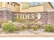 Stone sign for 'The Tides' community in a landscaped entrance, welcoming residents and guests at 3525 Hammock St, Las Vegas, NV 89147