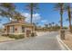 Community entrance with guard house, fountain, tall palm trees, and brick-paved street at 3525 Hammock St, Las Vegas, NV 89147