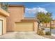 Exterior view of a two-story home featuring a two-car garage and neutral paint at 3525 Hammock St, Las Vegas, NV 89147