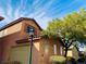 Inviting two-story home with a two-car garage, a charming tree, and plenty of curb appeal at 3525 Hammock St, Las Vegas, NV 89147