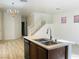Kitchen view with stainless steel sink, hardwood flooring and decorative chandelier at 3525 Hammock St, Las Vegas, NV 89147