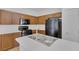 Kitchen featuring dark wood cabinets, white countertops, and black appliances at 3525 Hammock St, Las Vegas, NV 89147