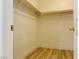 Compact walk-in closet featuring wood-style flooring and ample shelving for organizing at 3525 Hammock St, Las Vegas, NV 89147