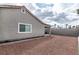 View of the home's backyard with gravel and a partially-covered patio at 3645 E Viking Rd, Las Vegas, NV 89121