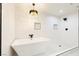 Bright bathroom featuring a modern tub, chic lighting and clean, modern design at 3645 E Viking Rd, Las Vegas, NV 89121