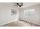 Bright bedroom with wood floors, a ceiling fan, and a large window at 3645 E Viking Rd, Las Vegas, NV 89121