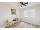 Cozy bedroom with wood floors, a ceiling fan, and a decorative accent wall at 3645 E Viking Rd, Las Vegas, NV 89121