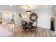Stylish dining area with decorative mirror, modern chandelier, and adjacent kitchen area at 3645 E Viking Rd, Las Vegas, NV 89121