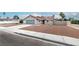 Charming single-story home with a low-pitched roof, a two-car garage, and manicured gravel front yard at 3645 E Viking Rd, Las Vegas, NV 89121