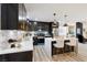 Spacious kitchen featuring an island with seating, modern appliances, and dark cabinets with gold hardware at 3645 E Viking Rd, Las Vegas, NV 89121