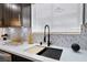 Close-up of kitchen sink and countertops, featuring modern fixtures and stylish backsplash at 3645 E Viking Rd, Las Vegas, NV 89121