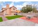 Backyard features well-maintained lawn, patio area, privacy fence and outdoor grilling area at 3744 Archer St, Las Vegas, NV 89108