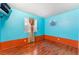 Bright bedroom with hardwood flooring, a cozy window, and two-tone walls at 3744 Archer St, Las Vegas, NV 89108