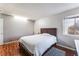 Bedroom featuring a wooden bed frame, window, and light hardwood floors at 3744 Archer St, Las Vegas, NV 89108