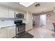 Traditional kitchen featuring white cabinets, stainless steel appliances, and tile flooring at 3744 Archer St, Las Vegas, NV 89108