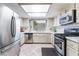 Bright kitchen with stainless steel appliances, tiled backsplash, and ample cabinet space at 3744 Archer St, Las Vegas, NV 89108