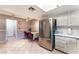 Spacious kitchen with stainless steel refrigerator and a dining area with table and chairs at 3744 Archer St, Las Vegas, NV 89108