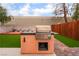 Backyard built in stainless steel grill on stucco base with storage in a manicured fenced yard at 3744 Archer St, Las Vegas, NV 89108