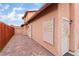 Side exterior showing a long walkway with brick pavers and security doors with sunburst design at 3744 Archer St, Las Vegas, NV 89108
