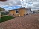 Backyard featuring brick pavers, artificial turf, and unfinished outbuilding at 4342 E Russell Rd, Las Vegas, NV 89120