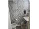 Modern bathroom features elegant marble-look tiling, a pedestal sink and updated fixtures at 4342 E Russell Rd, Las Vegas, NV 89120
