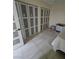 Bedroom featuring mirrored closet doors and tile floors, with a partial view of the bed at 4342 E Russell Rd, Las Vegas, NV 89120