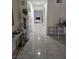 Bright hallway featuring tile floors, leading to living space with a fireplace at the end at 4342 E Russell Rd, Las Vegas, NV 89120