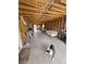 A large unfinished room with exposed wooden beams, a concrete floor and furnishings at 4342 E Russell Rd, Las Vegas, NV 89120