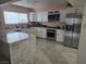 Bright kitchen with stainless steel appliances, white cabinets, and granite countertops at 4342 E Russell Rd, Las Vegas, NV 89120