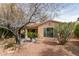 Cozy backyard featuring gravel landscaping, mature trees, and a covered patio with outdoor seating at 5029 Alfingo St, Las Vegas, NV 89135