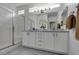 Elegant bathroom with dual sinks, marble countertops, and a glass-enclosed shower, designed for luxury and convenience at 5029 Alfingo St, Las Vegas, NV 89135