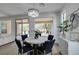 Bright dining area featuring a modern chandelier, round table, and views of the landscaped backyard at 5029 Alfingo St, Las Vegas, NV 89135