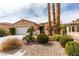 Inviting single-story home featuring a two-car garage, desert landscaping and a gated front entry at 5029 Alfingo St, Las Vegas, NV 89135