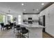 Bright, open kitchen with an island, marble countertops, stainless appliances, and adjacent dining area at 5029 Alfingo St, Las Vegas, NV 89135