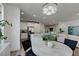Bright and open kitchen, adjacent to the dining area, featuring white cabinets, stainless steel appliances and island at 5029 Alfingo St, Las Vegas, NV 89135