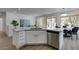 Bright kitchen featuring white cabinets, marble countertops, and stainless steel appliances, perfect for modern living at 5029 Alfingo St, Las Vegas, NV 89135